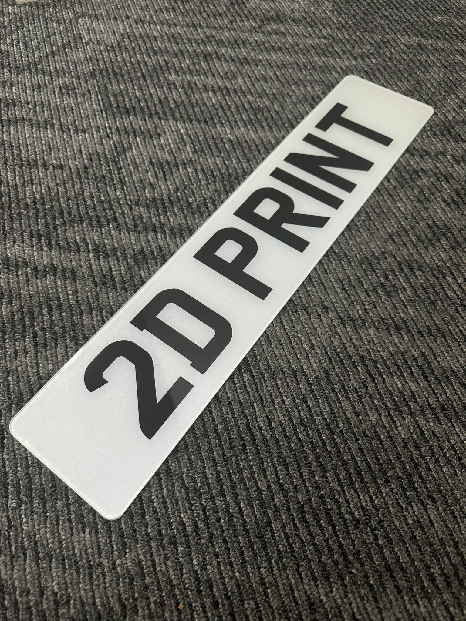 A standard 2D printed replacement number plate for a car in Newcastle.
